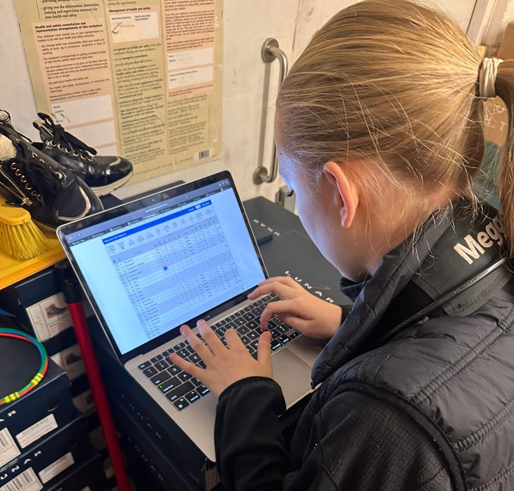 Electrician recording EICR results during a commercial electrical safety check in Blackpool.