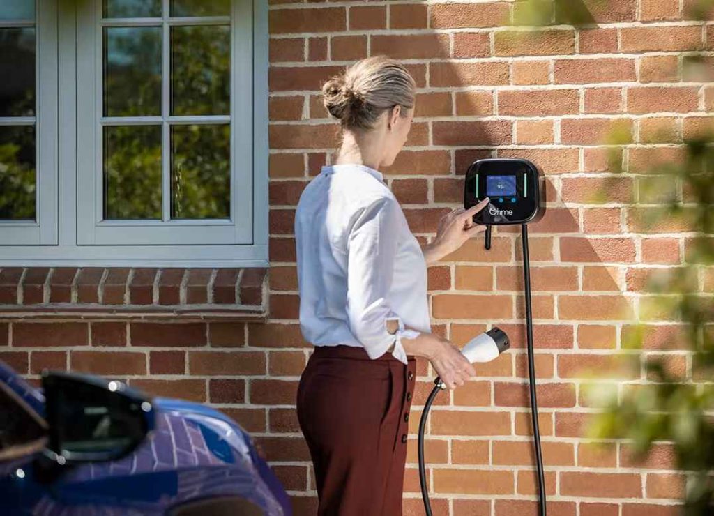 woman using a ohme charger at Blackpool home